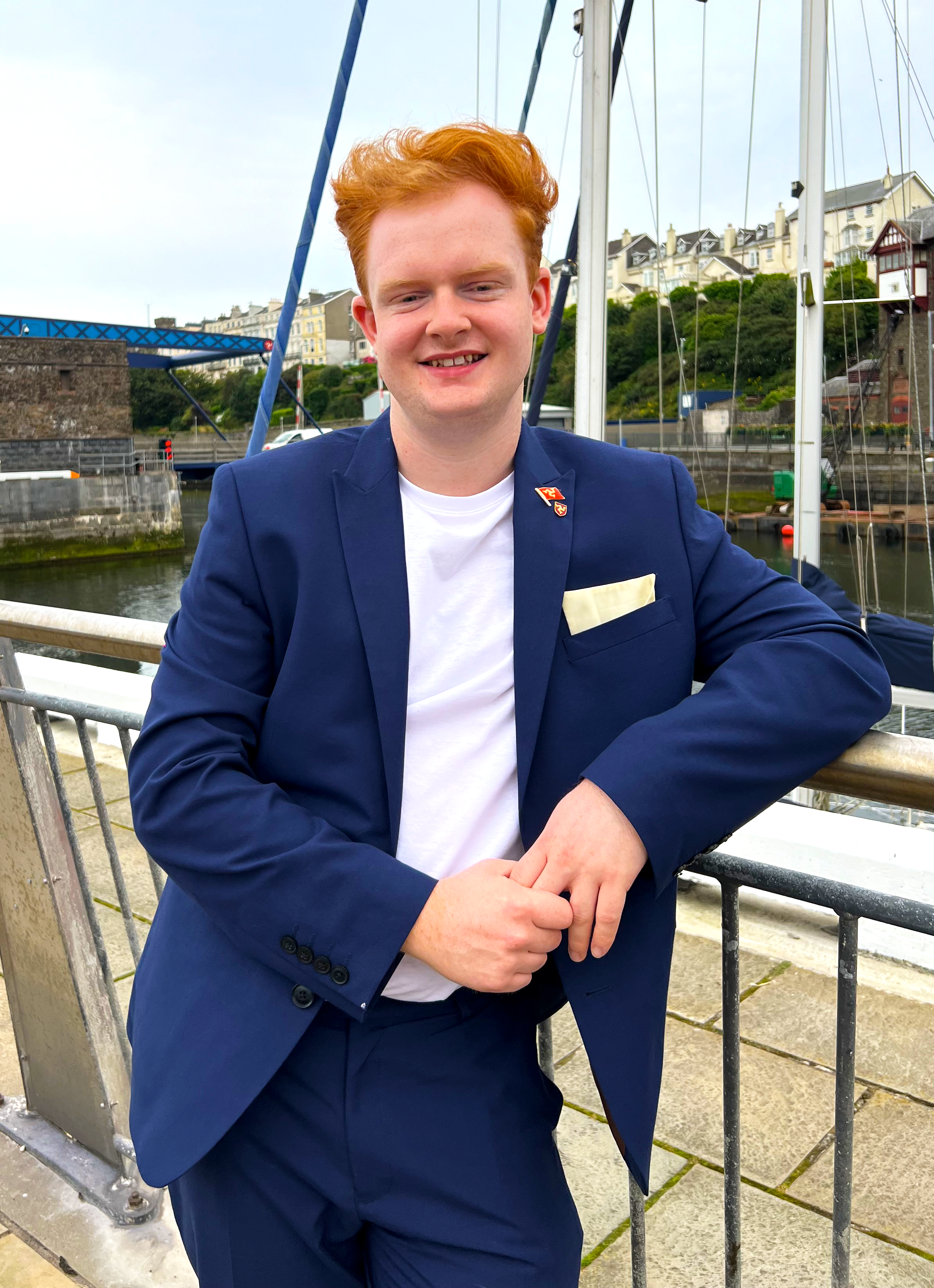 Adam stood in front of a quay with boats and a lifting bridge